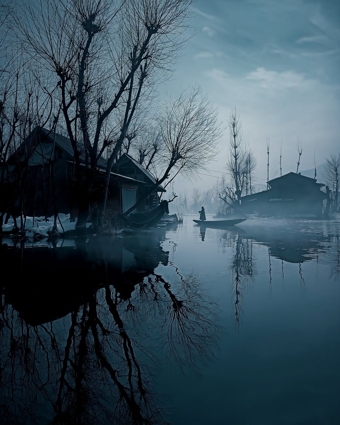 Winter is Coming. I captured this photograph during the peak of winter at Dal Lake, Srinagar. That morning was quiet and misty a man rowing his shikara through the cold waters, disappearing into the
