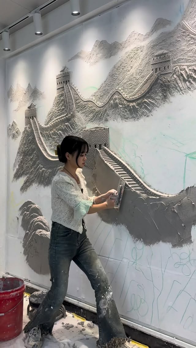 Daidai is a Chinese relief mural artist known for transforming walls into sculptural landscapes. Her large-scale works blend carving, modeling, and painting, creating immersive three-dimensional scene
