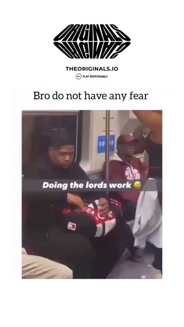 The video shows a crowded subway car where a woman in a black tank top is standing with her back to a seated man. As the train moves and she leans back, the man extends his hand to stop her from sitti