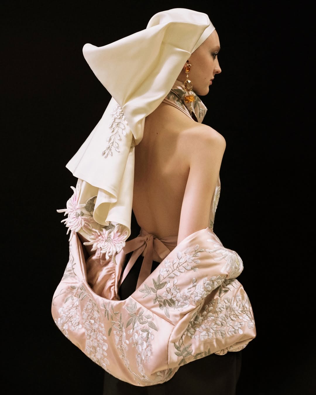 Ebba wears a satin embroidered cowl-neck draped top with satin embroidered bomber and cotton balloon trousers, and an embroidered T-shirt headwrap. Givenchy by Sarah Burton Styling Camilla Nickerso